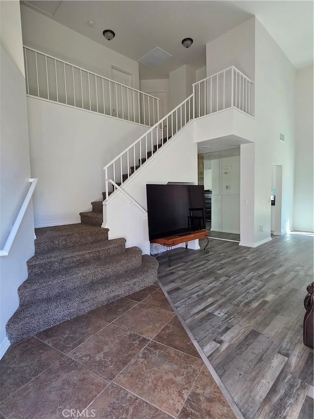 29390 Crest View Ln, Highland, CA 92346 - staircase with a towering ceiling and baseboards