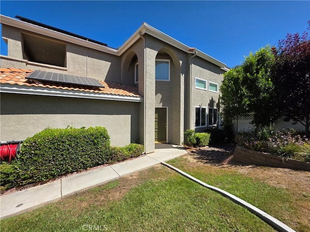 29390 Crest View Ln, Highland, CA 92346 - view of front of property featuring roof mounted solar panels, stucco siding, and a front yard