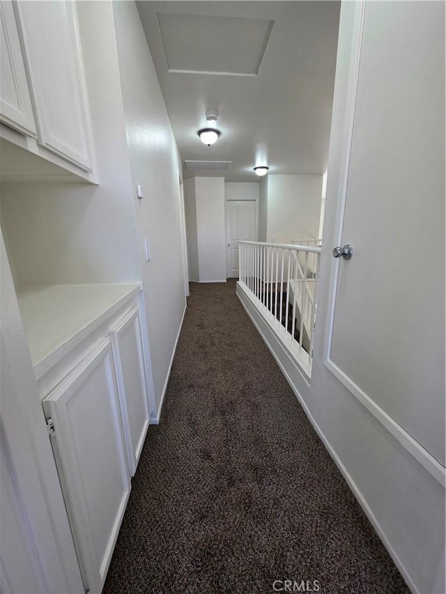 29390 Crest View Ln, Highland, CA 92346 - hallway featuring attic access and dark colored carpet
