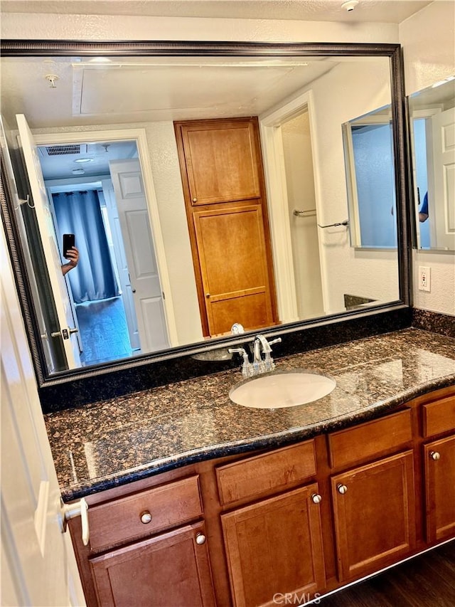 1025 La Terraza Cir Unit 204, Corona, CA 92879 - bathroom featuring vanity and wood finished floors