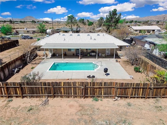 21919 Standing Rock Ave, Apple Valley, CA 92307 - view of pool featuring a fenced backyard, a patio area, a mountain view, and a residential view
