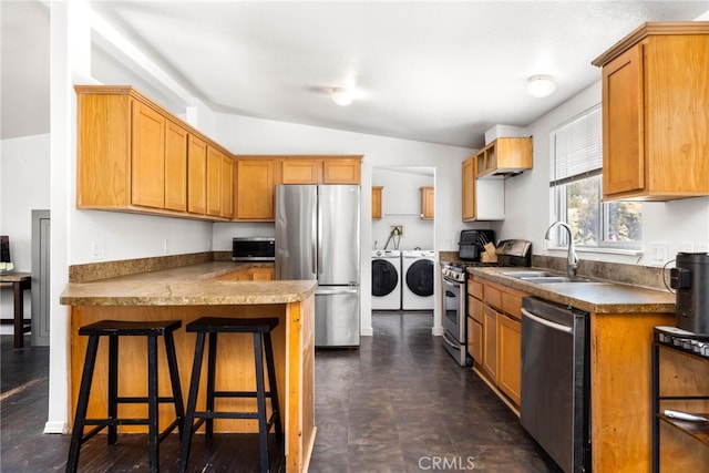 41605 De Portola Rd, Temecula, CA 92592 - kitchen featuring stainless steel appliances, separate washer and dryer, lofted ceiling, a peninsula, and a breakfast bar