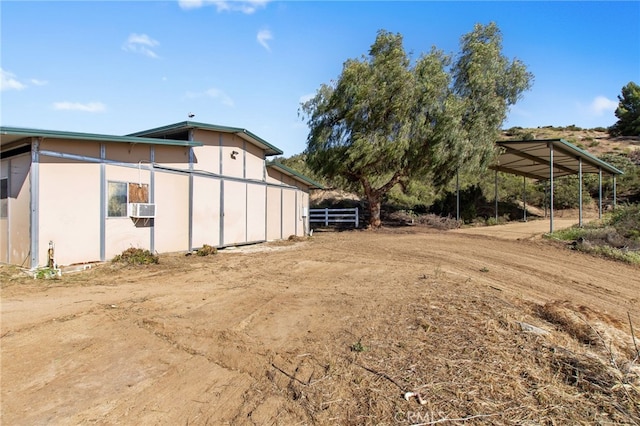 41605 De Portola Rd, Temecula, CA 92592 - view of side of home with stucco siding and cooling unit