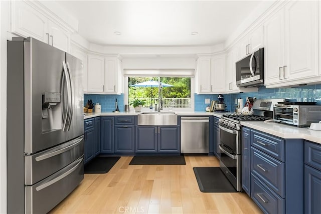 8009 E Eucalyptus Trl, Orange, CA 92869 - kitchen with stainless steel appliances, blue cabinets, white cabinets, and recessed lighting