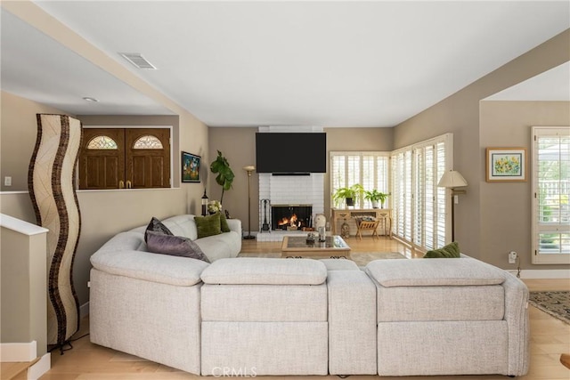 8009 E Eucalyptus Trl, Orange, CA 92869 - living room with a brick fireplace and light wood-type flooring