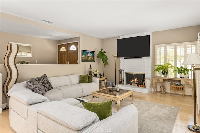 8009 E Eucalyptus Trl, Orange, CA 92869 - living area featuring plenty of natural light, wood finished floors, and a fireplace