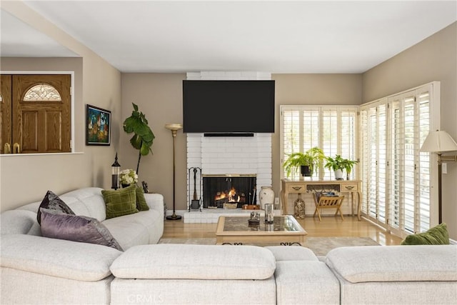 8009 E Eucalyptus Trl, Orange, CA 92869 - living room featuring a brick fireplace, healthy amount of natural light, and wood finished floors