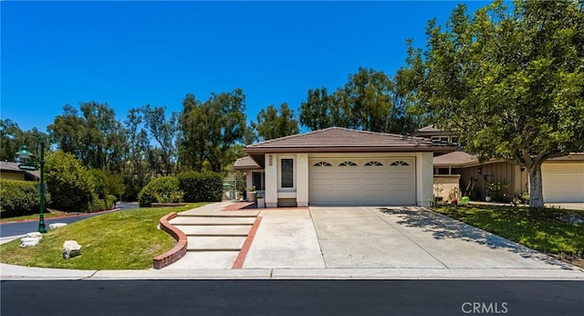 8009 E Eucalyptus Trl, Orange, CA 92869 - single story home with a tiled roof, a garage, a front lawn, concrete driveway, and stucco siding
