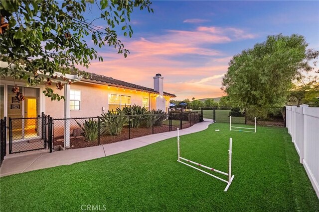 1708 Victoria Way, San Marcos, CA 92069 - yard at dusk featuring a gate