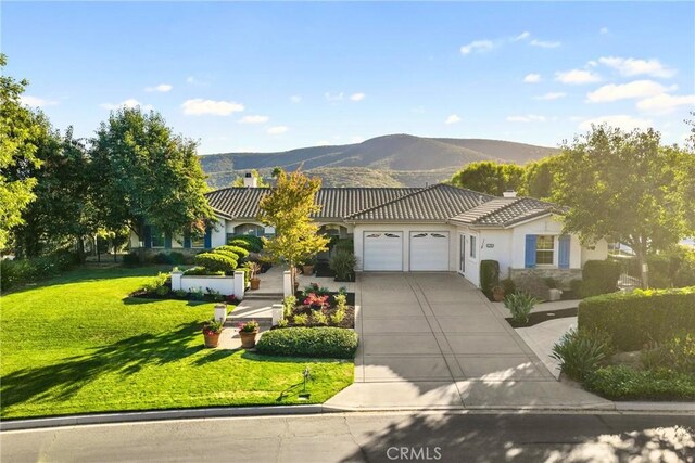 1708 Victoria Way, San Marcos, CA 92069 - view of front of home with a garage, a mountain view, a tile roof, a chimney, and concrete driveway