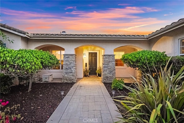 1708 Victoria Way, San Marcos, CA 92069 - exterior entry at dusk with stucco siding and stone siding