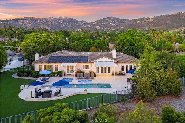 1708 Victoria Way, San Marcos, CA 92069 - back of property featuring an outdoor living space with a fire pit, a chimney, a tiled roof, outdoor dining space, and a fenced backyard