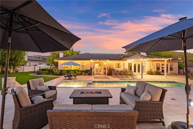 1708 Victoria Way, San Marcos, CA 92069 - patio terrace at dusk with an outdoor living space with a fire pit, french doors, an outdoor pool, and a patio area