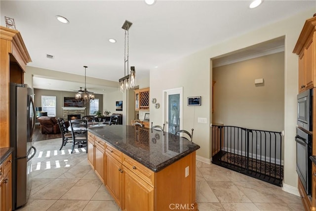 1708 Victoria Way, San Marcos, CA 92069 - kitchen with stainless steel appliances, a kitchen island, recessed lighting, open floor plan, and a stone fireplace