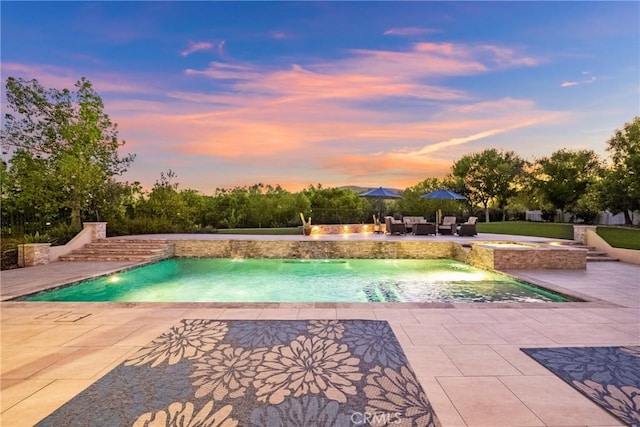 1708 Victoria Way, San Marcos, CA 92069 - pool at dusk featuring a patio area and a pool with connected hot tub
