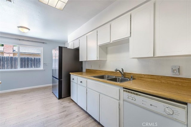 3318 Stanford Ave, Clovis, CA 93611 - kitchen with dishwasher, freestanding refrigerator, white cabinets, and light wood-type flooring