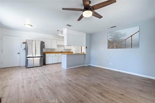 3318 Stanford Ave, Clovis, CA 93611 - kitchen featuring freestanding refrigerator, white cabinets, light wood finished floors, and ceiling fan