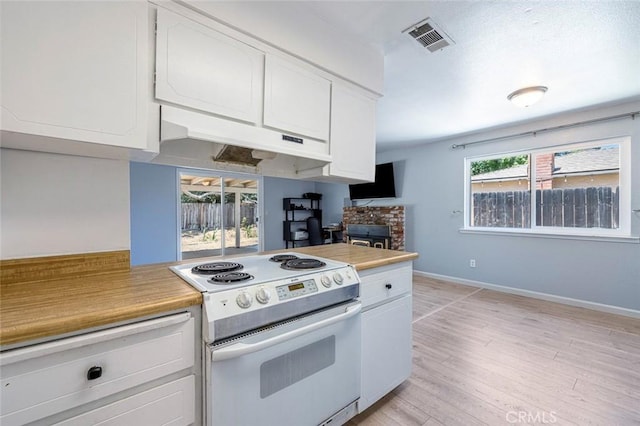 3318 Stanford Ave, Clovis, CA 93611 - kitchen with white electric range, white cabinetry, light countertops, and under cabinet range hood