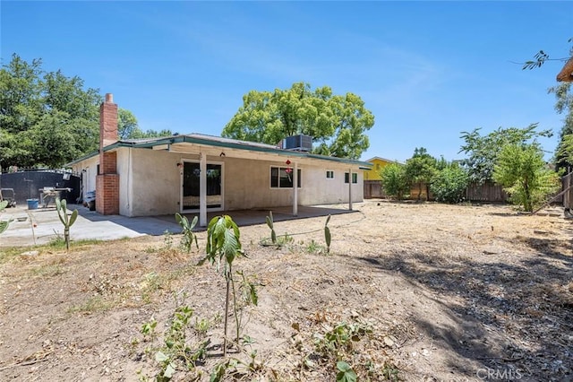 3318 Stanford Ave, Clovis, CA 93611 - rear view of house with a fenced backyard, a patio area, and a chimney