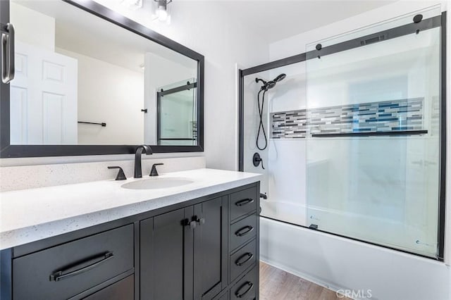 3318 Stanford Ave, Clovis, CA 93611 - bathroom featuring vanity, bath / shower combo with glass door, and wood finished floors