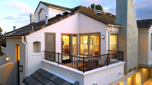 8 Diamant Way, Aliso Viejo, CA 92656 - rear view of property featuring stucco siding, a balcony, and a chimney