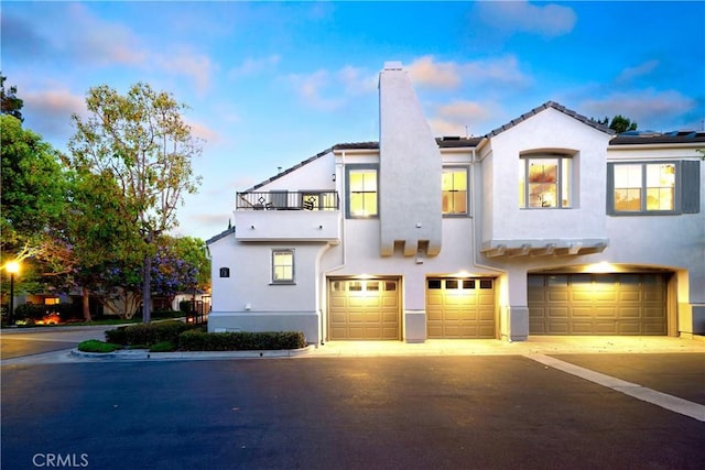 8 Diamant Way, Aliso Viejo, CA 92656 - view of front of property featuring a chimney, a balcony, an attached garage, and stucco siding