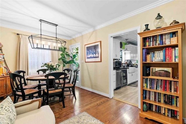 4328 Sunset Ave, Montrose, CA 91020 - dining space featuring a chandelier, light wood-style flooring, crown molding, and beverage cooler