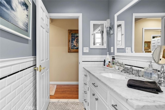 4328 Sunset Ave, Montrose, CA 91020 - bathroom with tile patterned flooring, vanity, tile walls, and a wainscoted wall