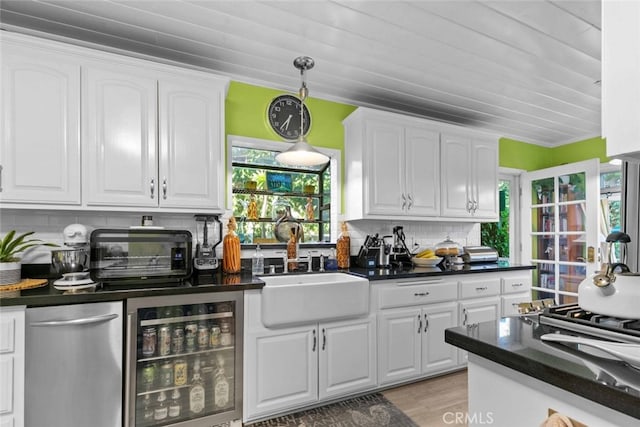 4328 Sunset Ave, Montrose, CA 91020 - kitchen featuring wine cooler, dark countertops, white cabinets, and decorative backsplash