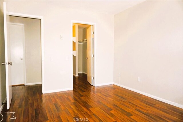 3550 Ruffin Rd Unit 142, San Diego, CA 92123 - unfurnished bedroom featuring a walk in closet, wood finished floors, and a closet