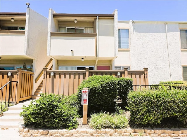 3550 Ruffin Rd Unit 142, San Diego, CA 92123 - back of house with stairway and stucco siding