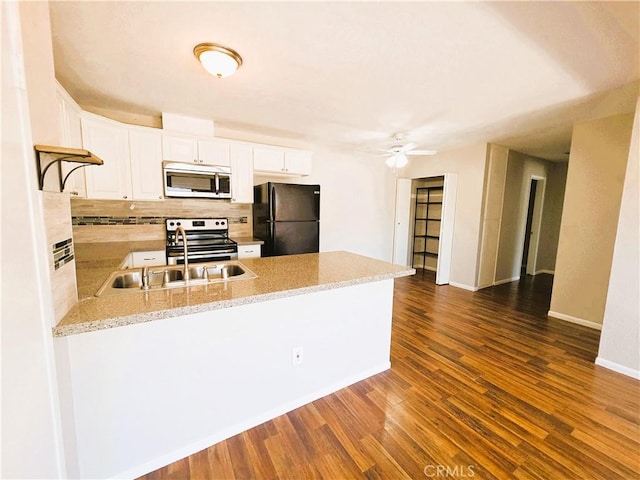3550 Ruffin Rd Unit 142, San Diego, CA 92123 - kitchen with stainless steel appliances, a peninsula, decorative backsplash, dark wood-style flooring, and white cabinetry