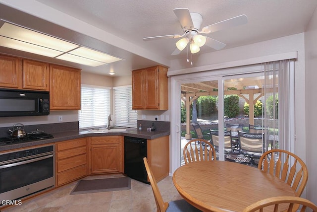 20325 Tamara Pl, Santa Clarita, CA 91350 - kitchen featuring black appliances, dark countertops, a ceiling fan, and brown cabinets