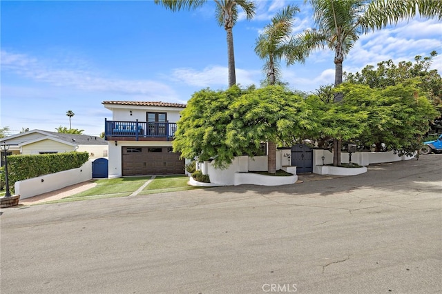490 Agate, Laguna Beach, CA 92651 - view of front of house featuring stucco siding, an attached garage, driveway, a gate, and a balcony