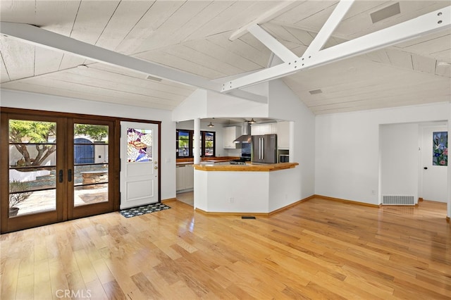 490 Agate, Laguna Beach, CA 92651 - kitchen with freestanding refrigerator, french doors, light wood finished floors, wall chimney range hood, and butcher block counters