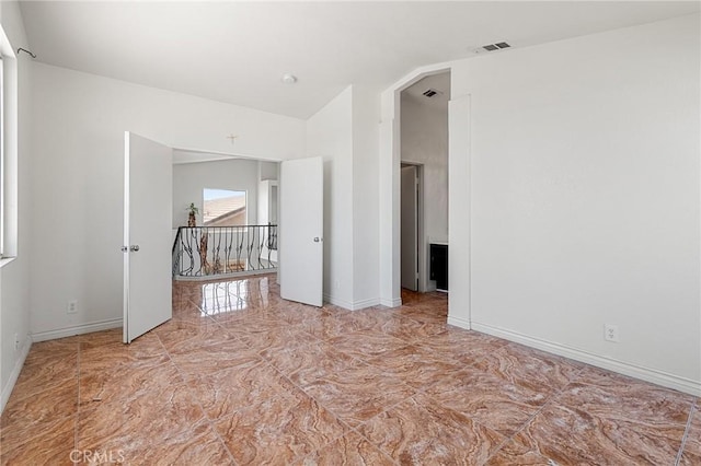 9304 Palo Verde Dr, Hesperia, CA 92344 - empty room featuring light marble finish flooring and vaulted ceiling