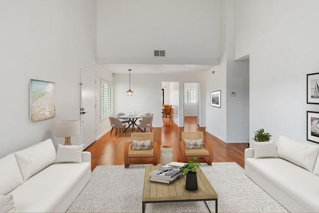 8004 Caminito Gianna, La Jolla, CA 92037 - living room featuring a towering ceiling and wood finished floors