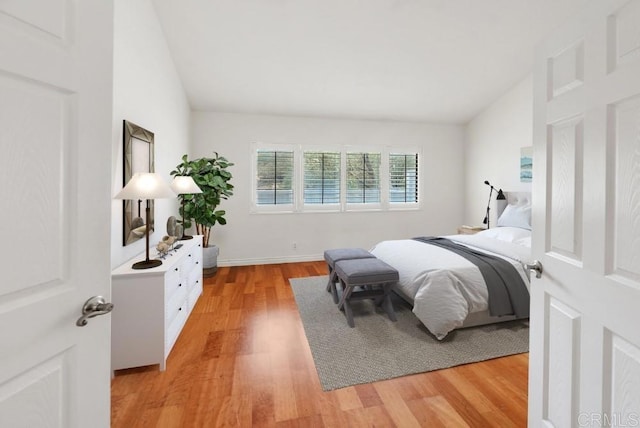 8004 Caminito Gianna, La Jolla, CA 92037 - bedroom with vaulted ceiling and light wood-style floors