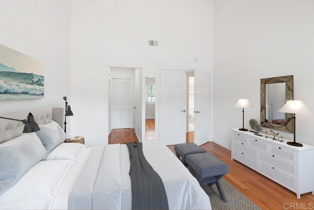 8004 Caminito Gianna, La Jolla, CA 92037 - bedroom featuring wood finished floors and a towering ceiling