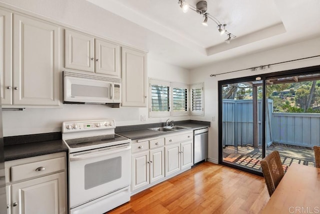 8004 Caminito Gianna, La Jolla, CA 92037 - kitchen featuring white appliances, light wood-style floors, dark countertops, and white cabinetry