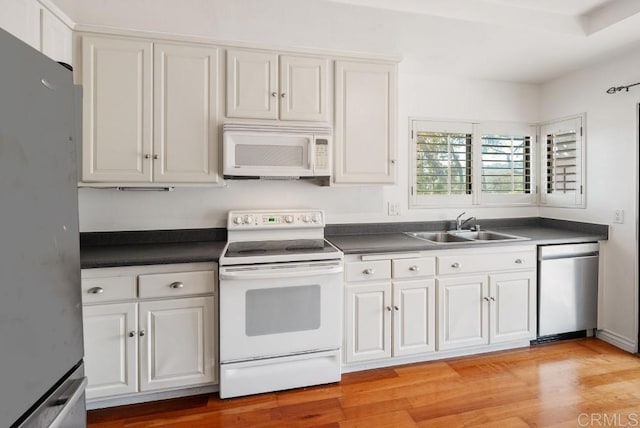 8004 Caminito Gianna, La Jolla, CA 92037 - kitchen featuring white appliances, dark countertops, white cabinetry, and light wood-type flooring
