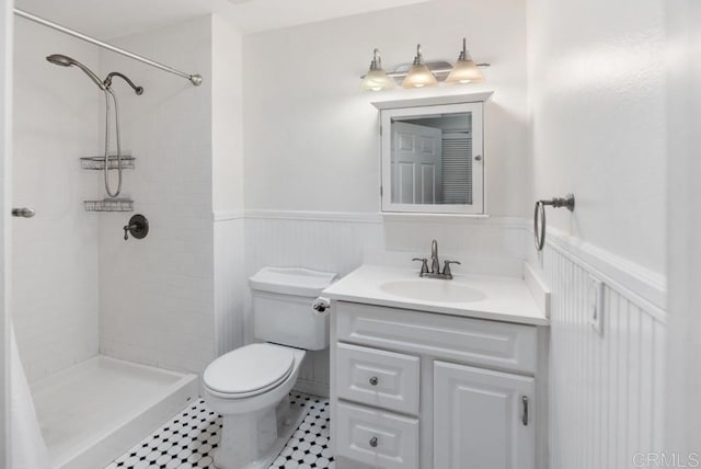 8004 Caminito Gianna, La Jolla, CA 92037 - full bath with wainscoting, vanity, a tile shower, and tile patterned floors
