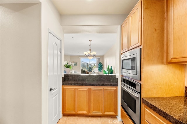 4025 Canario St Unit 142, Carlsbad, CA 92008 - kitchen featuring stainless steel appliances, tile counters, a chandelier, light tile patterned floors, and decorative light fixtures