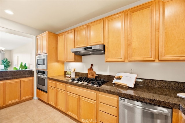 4025 Canario St Unit 142, Carlsbad, CA 92008 - kitchen with appliances with stainless steel finishes, under cabinet range hood, light brown cabinets, light tile patterned floors, and a chandelier