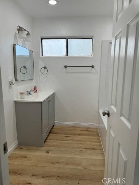 1025 N Tippecanoe Ave Unit 132, San Bernardino, CA 92410 - bathroom with vanity, wood finished floors, and recessed lighting