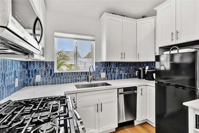 1402 E Rose Ave, Orange, CA 92867 - kitchen featuring stainless steel appliances, light countertops, white cabinets, and decorative backsplash