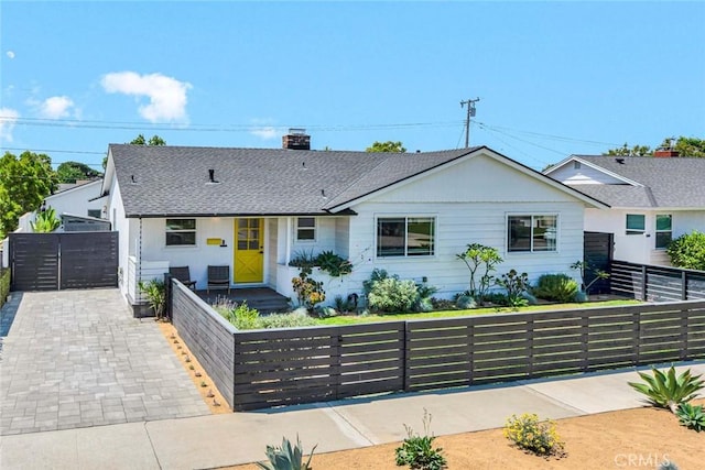 1402 E Rose Ave, Orange, CA 92867 - view of front of house with a fenced front yard, a chimney, roof with shingles, and a gate