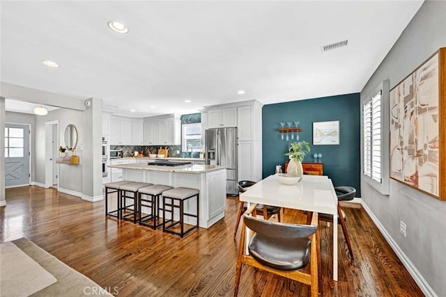 1402 E Rose Ave, Orange, CA 92867 - dining room featuring dark wood-style flooring, healthy amount of natural light, and recessed lighting