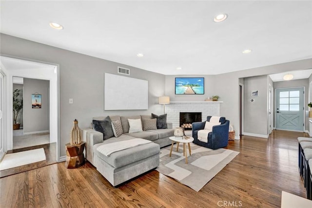1402 E Rose Ave, Orange, CA 92867 - living area with wood finished floors, a brick fireplace, and recessed lighting