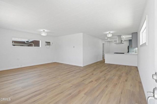 341 1st St, Fillmore, CA 93015 - unfurnished living room featuring light wood-style floors and a wall unit AC